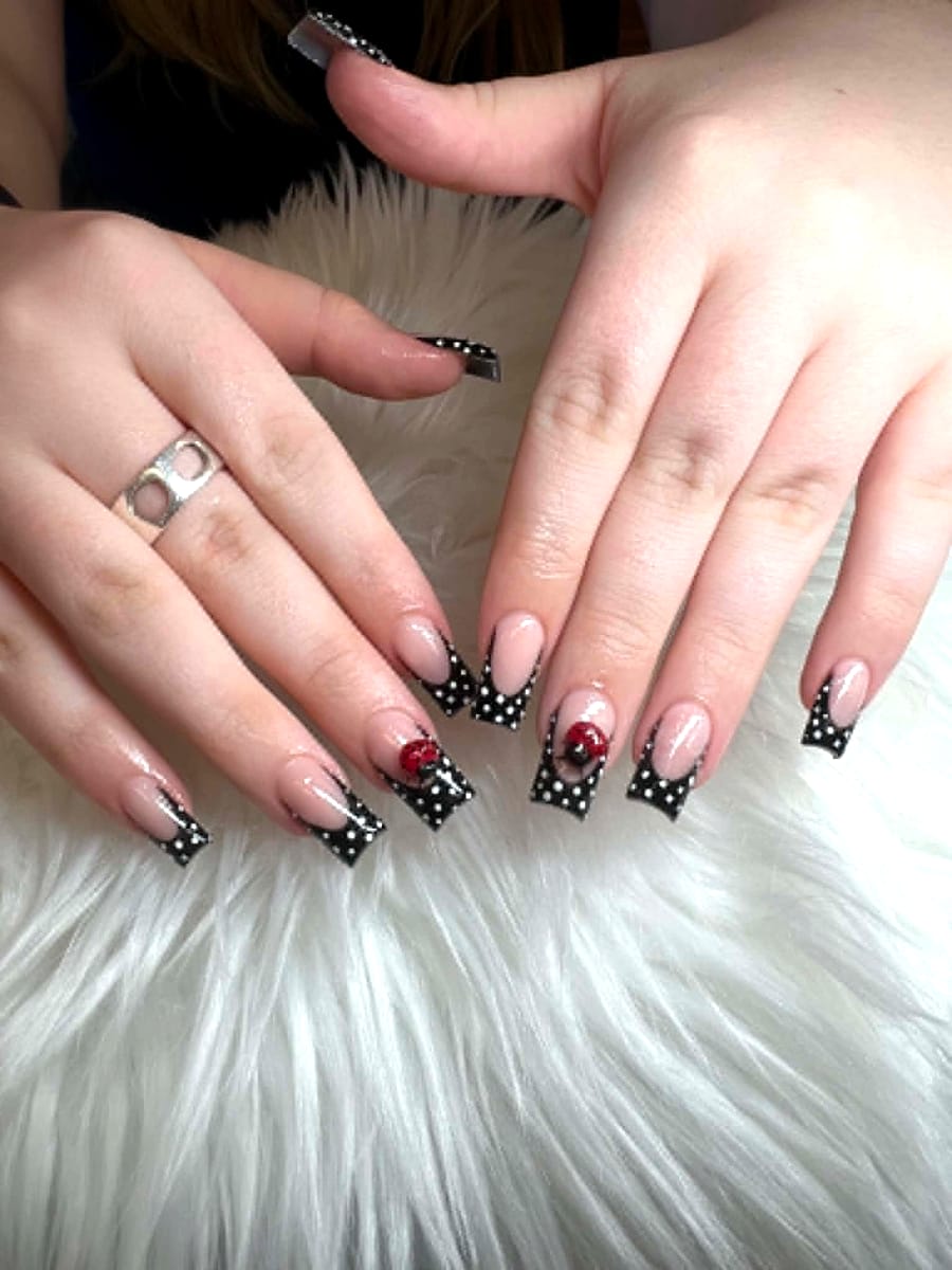 Black polka-dot French tips with red bead accent nails