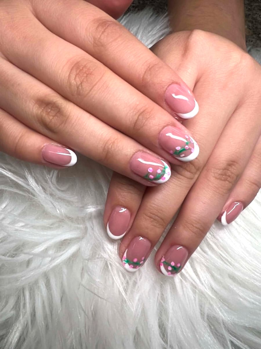 Classic pink and white French manicure with cherry blossom hand-paint