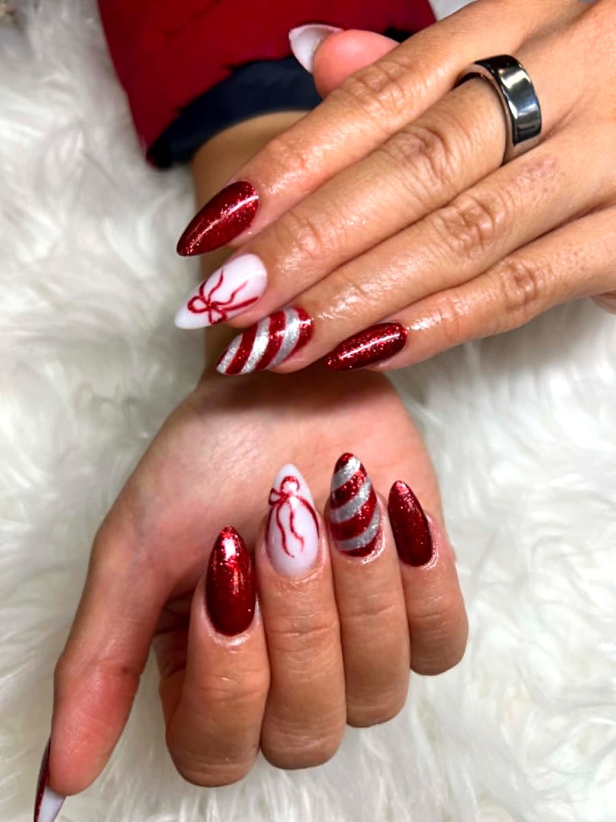 Festive red glitter and candy-cane stripe Christmas manicure
