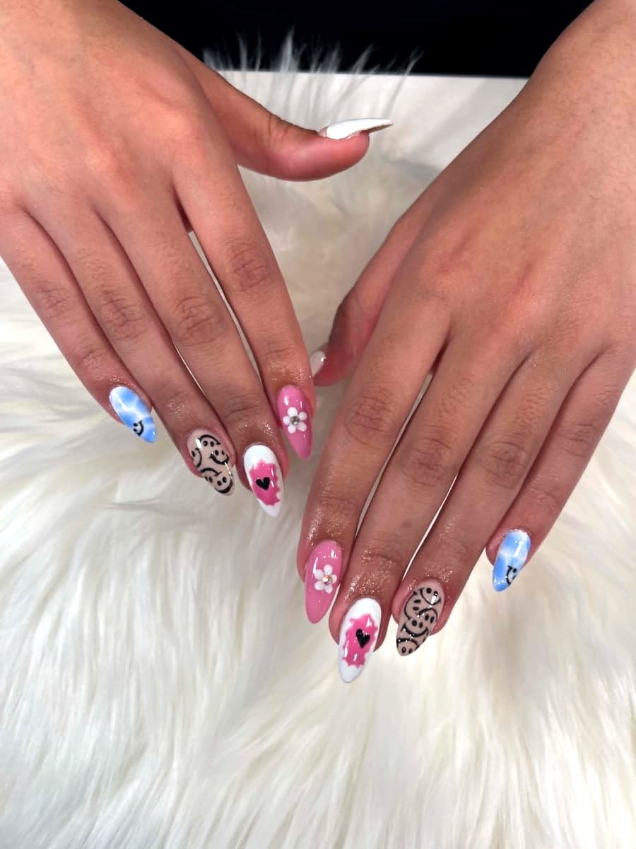 Y2K-style smiley face, sky cloud, and pink heart accent nail art