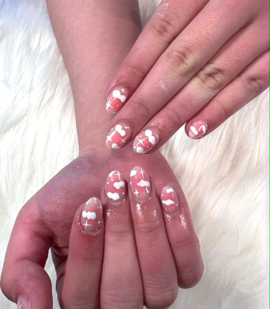 Sheer pink short manicure with white cloud and sparkle art